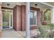 Inviting front porch featuring brick accents, white columns, and a view of the landscaped yard at 102 Brutus Ln, Summerville, SC 29485