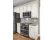 Modern kitchen with stainless steel appliances, granite countertops, and white cabinets with black hardware at 102 Brutus Ln, Summerville, SC 29485