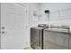 Laundry room with modern washer and dryer, white cabinets, and white door at 102 Brutus Ln, Summerville, SC 29485