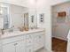 Elegant bathroom with dual sinks, quartz countertops, and a spacious walk-in closet at 1020 Sagegrass St, Summerville, SC 29485