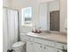 Bright bathroom with a large vanity, ample storage, and a window offering natural light at 1020 Sagegrass St, Summerville, SC 29485