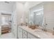 Bright bathroom featuring double sinks, quartz countertops, and a luxurious walk-in shower at 1020 Sagegrass St, Summerville, SC 29485