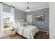 Stylish bedroom featuring patterned wallpaper, ample natural light, and modern decor at 1020 Sagegrass St, Summerville, SC 29485