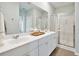 Elegant bathroom featuring double sinks, a large mirror, and a glass-enclosed shower for a spa-like experience at 1025 Swamp Rose Run, Summerville, SC 29485