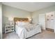 Cozy bedroom with a woven headboard, plush bedding, and neutral tones creating a relaxing atmosphere at 1025 Swamp Rose Run, Summerville, SC 29485