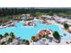 Aerial view of a luxurious community pool surrounded by lounge chairs and lush landscaping at 1025 Swamp Rose Run, Summerville, SC 29485
