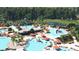 Aerial view of a community pool featuring a splashpad, waterslide, lounge chairs and seating areas at 1025 Swamp Rose Run, Summerville, SC 29485