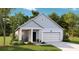 Charming one-story home with light blue siding, a covered front porch, and an attached two-car garage at 1025 Swamp Rose Run, Summerville, SC 29485