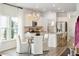 An open-concept kitchen with white cabinetry, granite countertops, a large island, and stainless steel appliances at 1025 Swamp Rose Run, Summerville, SC 29485