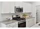 Modern kitchen with stainless steel appliances, granite countertops and white cabinetry at 1025 Swamp Rose Run, Summerville, SC 29485