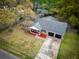 Overhead view of a brick home, attached garage, and front yard landscaped with a prominent tree at 103 Beverly Dr, Ladson, SC 29456