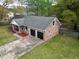 Birds-eye view of a red-brick house featuring an attached two-car garage and lush greenery at 103 Beverly Dr, Ladson, SC 29456
