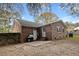 Brick home exterior with a grill, fenced yard, and small patio at 103 Beverly Dr, Ladson, SC 29456