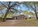 Brick house exterior with a fenced yard and mature tree canopy at 103 Beverly Dr, Ladson, SC 29456