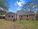 Brick house exterior with a fenced yard and mature tree canopy at 103 Beverly Dr, Ladson, SC 29456