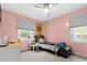 Pink bedroom with a window for natural light and a ceiling fan at 103 Beverly Dr, Ladson, SC 29456