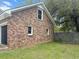 Brick house exterior with a garage door and fenced yard at 103 Beverly Dr, Ladson, SC 29456