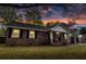 Charming brick home with black shutters, attached garage, and welcoming front porch at sunset at 103 Beverly Dr, Ladson, SC 29456