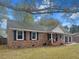 Brick ranch home with charming front porch, two-car garage, and landscaped yard at 103 Beverly Dr, Ladson, SC 29456