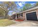 View of brick house and attached garage; charming front porch; well maintained lawn at 103 Beverly Dr, Ladson, SC 29456