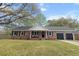 Charming brick ranch with two-car garage, landscaped yard, and covered front porch at 103 Beverly Dr, Ladson, SC 29456