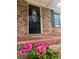 Close up of front door with glass detail, potted pink flowers, and decorative plants at 103 Beverly Dr, Ladson, SC 29456