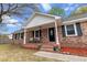 A classic red brick home with a covered front porch and black shutters at 103 Beverly Dr, Ladson, SC 29456