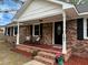 Inviting front porch with seating, landscaping, and a welcoming entryway at 103 Beverly Dr, Ladson, SC 29456