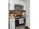 The kitchen features stainless steel appliances, modern cabinets, and stylish tile backsplash at 103 Beverly Dr, Ladson, SC 29456