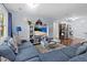 A wide shot of the living room featuring hardwood floors, neutral paint, and a large, comfortable sofa at 103 Beverly Dr, Ladson, SC 29456