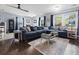 The living room features a stylish blue sofa, dark hardwood floors, and plenty of natural light at 103 Beverly Dr, Ladson, SC 29456