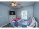 Bright bedroom with a bed, dresser, and large window. A cozy retreat for relaxation and rest at 104 Cranston Ln, Summerville, SC 29483