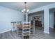 Cozy dining room featuring a round wooden table, chandelier lighting, and decorative wall art at 104 Cranston Ln, Summerville, SC 29483
