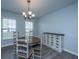 Bright dining area with a round wooden table, chandelier, and a decorative sideboard at 104 Cranston Ln, Summerville, SC 29483