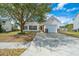 Single-story home with attached garage, mature tree, and well-maintained lawn and driveway at 104 Cranston Ln, Summerville, SC 29483