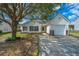 Beautifully maintained single-story home with attached garage, mature tree, and manicured landscaping at 104 Cranston Ln, Summerville, SC 29483