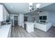 Spacious kitchen with white cabinets, stainless steel appliances, and seamless living room access at 104 Cranston Ln, Summerville, SC 29483