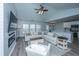 Bright living room boasts a modern fireplace, large windows, and a comfortable seating arrangement at 104 Cranston Ln, Summerville, SC 29483