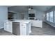 Bright open-concept living room features white fireplace and shiplap accents with modern flooring at 104 Cranston Ln, Summerville, SC 29483
