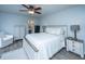 Bright main bedroom with white furnishings, fan, and decorative pillows and accents at 104 Cranston Ln, Summerville, SC 29483