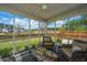 Relaxing screened porch with cozy chairs and a unique wooden coffee table, perfect for enjoying outdoor views at 104 Cranston Ln, Summerville, SC 29483