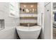 Modern bathroom features a luxurious free-standing tub with decorative shelving and marble accents at 105 N Gateshead Xing Xing, Goose Creek, SC 29445