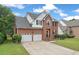 Charming brick two-story home with a two-car garage and well-manicured lawn at 105 N Gateshead Xing Xing, Goose Creek, SC 29445