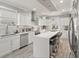 Bright kitchen with white cabinetry, stainless steel appliances, and large center island with bar stool seating at 105 N Gateshead Xing Xing, Goose Creek, SC 29445