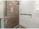 Modern shower features a rainfall showerhead and beautiful marble and wood look accent tiles at 105 N Gateshead Xing Xing, Goose Creek, SC 29445