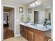 Bathroom boasting a double vanity, framed mirror, and an open doorway to the bedroom at 113 Blackwater Way, Moncks Corner, SC 29461