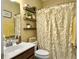 Stylish bathroom featuring decorative floating shelves and a shower with a patterned curtain at 113 Blackwater Way, Moncks Corner, SC 29461