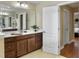 Bathroom with double vanity, cabinets, a large mirror, and an open doorway to the bedroom at 113 Blackwater Way, Moncks Corner, SC 29461