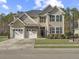 Charming two-story home with three-car garage, well-manicured lawn, and mature trees at 113 Blackwater Way, Moncks Corner, SC 29461