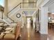 Spacious hallway with hardwood floors, open staircase, and abundant natural light at 113 Blackwater Way, Moncks Corner, SC 29461